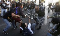 Mexican police charge down protesters against Enrique Peña Nieto, who has taken office as president.